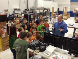 Bobby Richardson, Director of Operations at Sealevel Systems Inc., demonstrates circuit board assembly to Crosswell Elementary STEM Club.