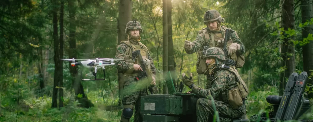 3 military men operating a drone