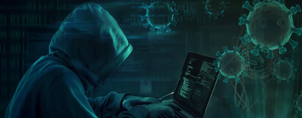 Stylized image showing a depiction of a computer hacker with an overlay of the coronavirus
